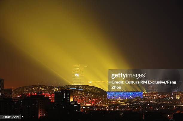 floodlit birds nest stadium at night during olympics, beijing, china - glow rm fotografías e imágenes de stock