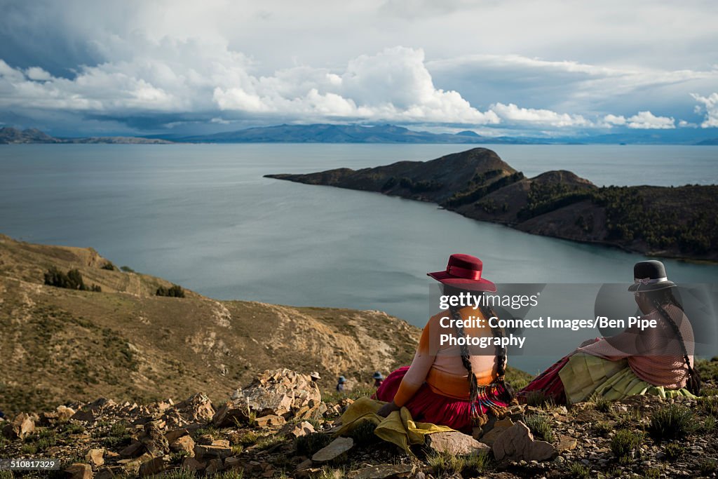 Two women in traditional clothing on the Inca trail, Isla del Sol, Lake Titicaca, Bolivia, South America