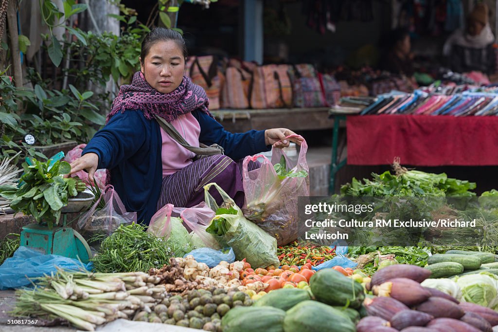 Woman at street market selling vegetables, Luang Prabang, Laos, Southeast Asia