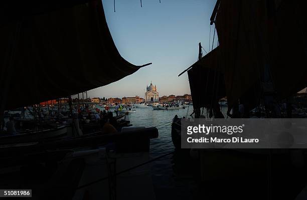 Venetians have dinner at their boats as they wait for the fireworks in the lagoon to celebrate during the Festa del Redentore in Venice July 17,...