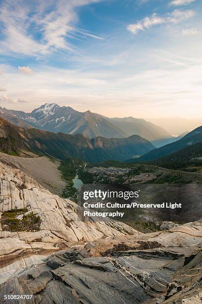 glacier pond below the glacier eroded cliffs near the macbeth icefields, purcell mountains, kootenay region, british columbia, canada - macbeth icefields stock pictures, royalty-free photos & images