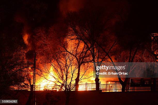 Firefighter tries to put out a fire as Turkish army busses burn after an explosion on February 17, 2016 in Ankara, Turkey. At least five people have...