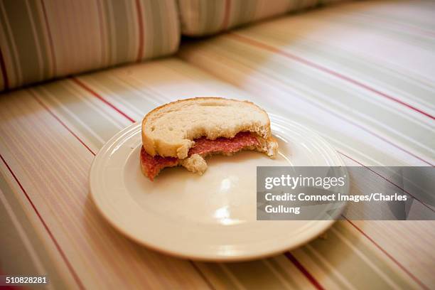 half eaten sandwich on plate - eaten foto e immagini stock