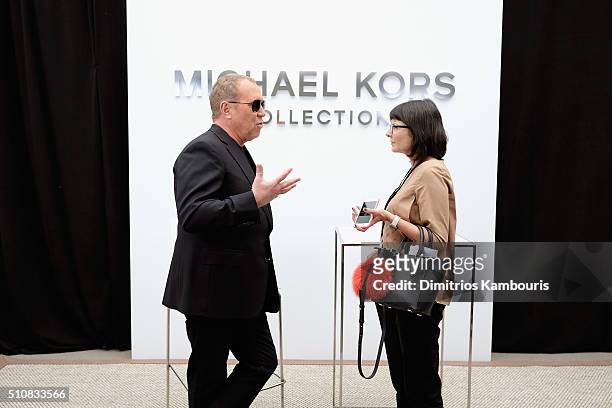 Designer Michael Kors prepares backstage at the Michael Kors Fall 2016 Runway Show during New York Fashion Week: The Shows at Spring Studios on...