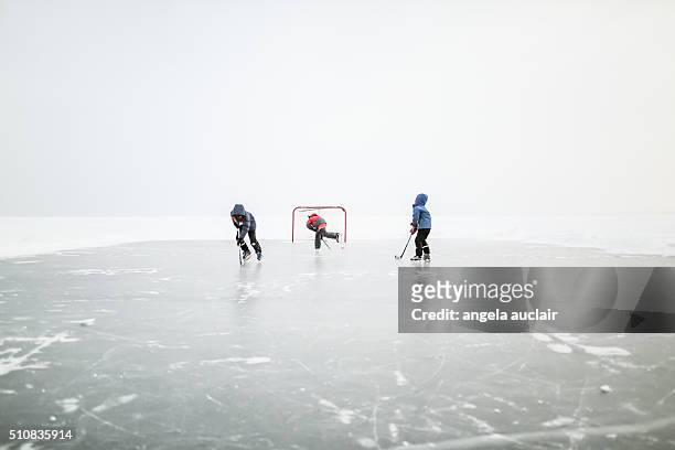 skating on a lake in canada - canada hockey fotografías e imágenes de stock