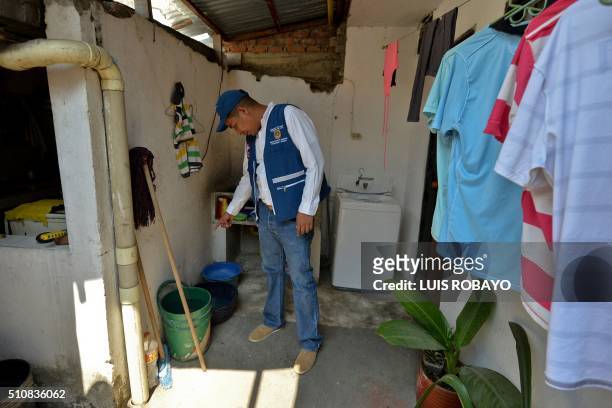 Cali's Secretary of Health Alexander Duran checks bowls at a house in Cali, Colombia on February 17, 2016. Cali's Health Secretariat massively...