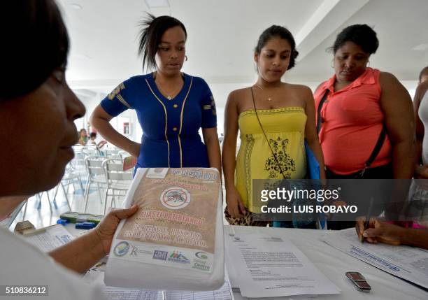 Workers of the Health Secretariat hands mosquito nets to pregnant women on February 17 in Cali, Colombia. Cali's Health Secretariat massively...