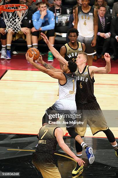 Angelo Russell of the USA Team shoots the ball against Kristaps Porzingis of the World Team during the BBVA Compass Rising Stars Challenge as part of...