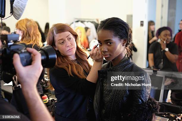 Model prepares backstage at the Michael Kors Fall 2016 Runway Show during New York Fashion Week: The Shows at Spring Studios on February 17, 2016 in...