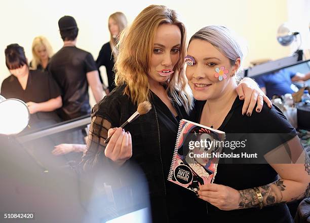 Model poses with a makeup artist backstage at the Michael Kors Fall 2016 Runway Show during New York Fashion Week: The Shows at Spring Studios on...