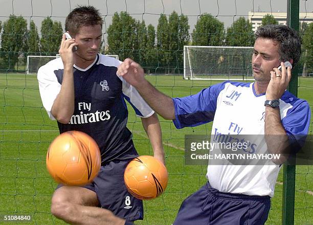 Frank Lampard of Chelsea Football club and coach Jose Mourinho pose with a ball 20 July 2004 at Heathrow training ground. It was announced today that...