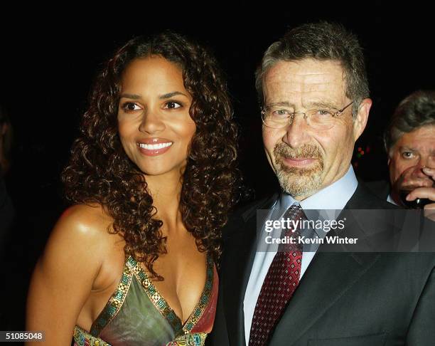 Actress Halle Berry and Warner Bros. Barry Meyer pose at the after-party for the premiere of Warner Bros. Pictures "Catwoman" at the Cinerama Dome on...