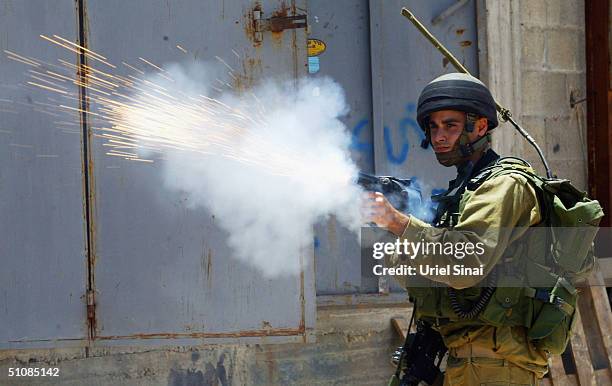 Israeli soldiers fire tear gas at Palestinian protestors as they demolish Palestinian buildings to make way for Israel?s separation barrier on July...