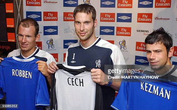 Three of Chelsea football club's new signings, Dutch winger Arjen Robben, Czech goalkeeper Petr Cech and Serbian striker Mateja Kezman pose with...