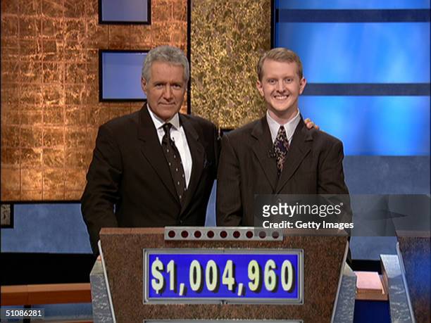 Jeopardy host Alex Trebek, poses contestant Ken Jennings after his earnings from his record breaking streak on the gameshow surpassed 1 million...