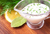 Creamy sauce with herbs on a table