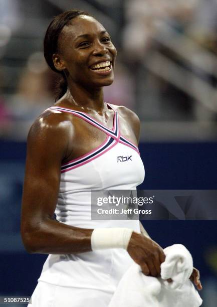 Venus Williams smiles following her 6-2, 6-1 victory over Ashley Harkleroad during the second round of the JP Morgan Chase Open on July 20, 2004 at...