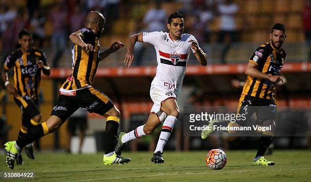 Alan Kardec of Sao Paulo fights for the ball with Ernesto Cristaldo of The Strongest during a match between Sao Paulo v The Strongest as part of...