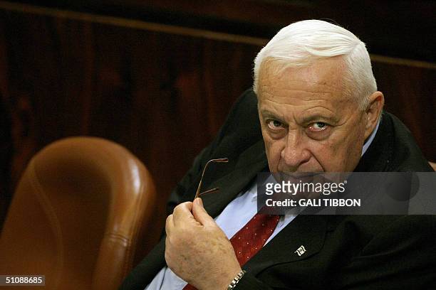 Israeli Prime Minister Ariel Sharon looks on during a parliamentary session at the Knesset in Jerusalem, 21 July 2004. Israel vowed to go ahead with...