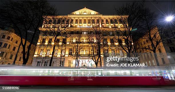 Picture taken with long exposure shows a tram driving past the Hotel Imperial in Vienna on February 17, 2016. The 138-room Hotel Imperial in Vienna...