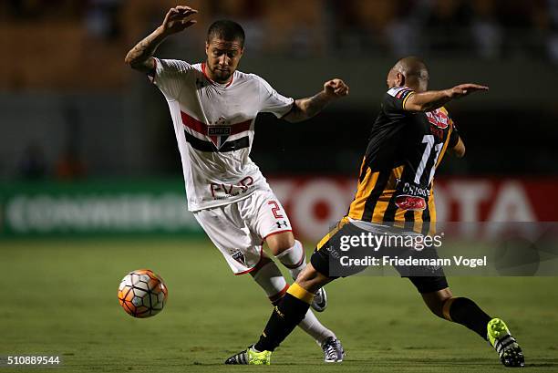 Renan Ribeiro of Sao Paulo fights for the ball with Ernesto Cristaldo of The Strongest during a match between Sao Paulo v The Strongest as part of...