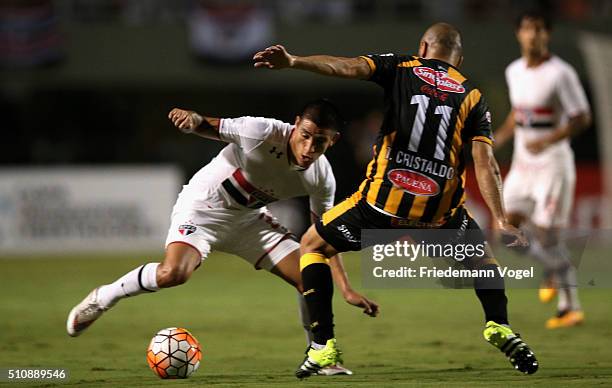 Renan Ribeiro of Sao Paulo fights for the ball with Ernesto Cristaldo of The Strongest during a match between Sao Paulo v The Strongest as part of...