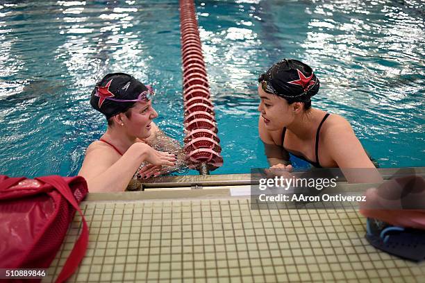 Missy Franklin jokes with Chinese olympian Tang Yi as they train at the Richie Center on the University of Denver Campus on Wednesday, February 17,...