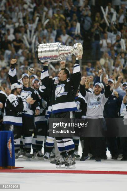 Dave Andreychuk of the Tampa Bay Lightning holds the Stanley Cup above his head after the victory over the Calgary Flames in Game seven of the NHL...