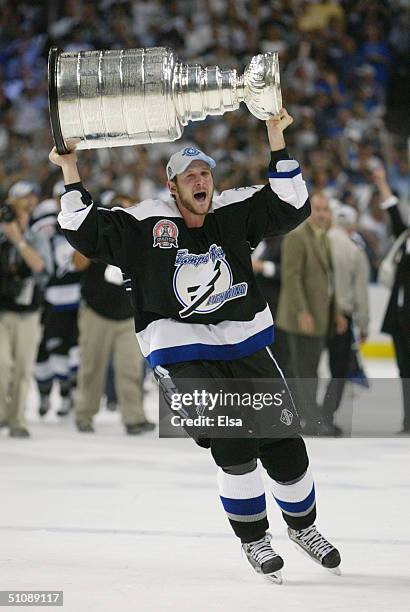 Nolan Pratt of the Tampa Bay Lightning skates with the Stanley Cup above his head after the victory over the Calgary Flames in Game seven of the NHL...