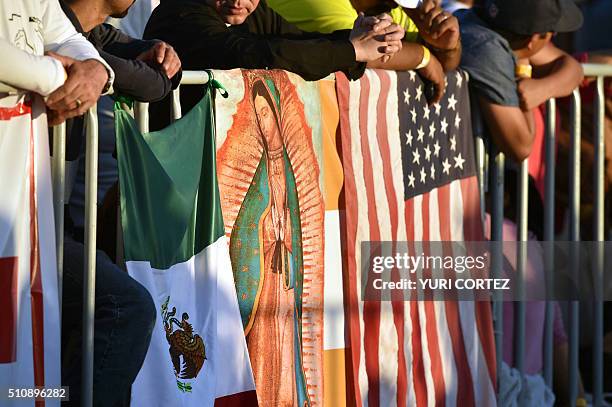 People wait for Pope Francis to celebrate mass with a Mexican and a US flag at the Ciudad Juarez fairground in Chihuahua state, Mexico on February...