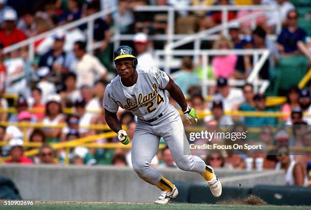 Outfielder Rickey Henderson of the Oakland Athletics leads off of first base against the Chicago White Sox during an Major League Baseball game circa...