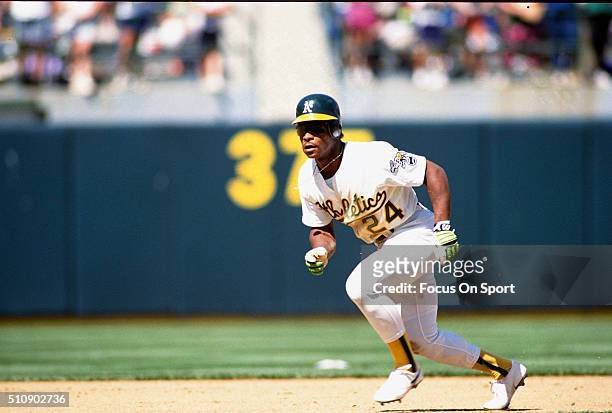 Outfielder Rickey Henderson of the Oakland Athletics leads off of second base during an Major League Baseball game circa 1991 at the Oakland-Alameda...