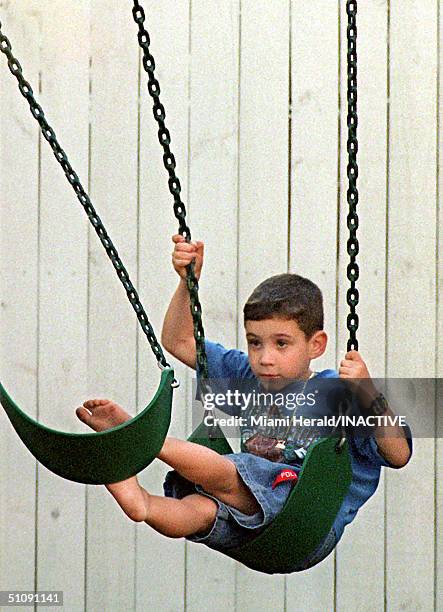 Elian Gonzalez Swings Outside His Little Havana Home April 8, 2000 Following A Rainstorm In Miami, Florida. The Family Of Elian Gonzalez Has Been...