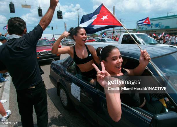 Protesters Hang Out The Window Of A Car On Flagler Street Heading West At Nw 57Th Ave., Waving Flags And Honking Horns To Protest The Justice Dept.'s...