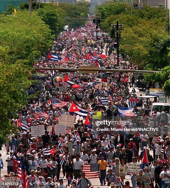 Thousands Of Protesters Pack A Street In Little Havana Carrying Flags And Signs During An Organized March April 29, 2000 In Miami. Many...