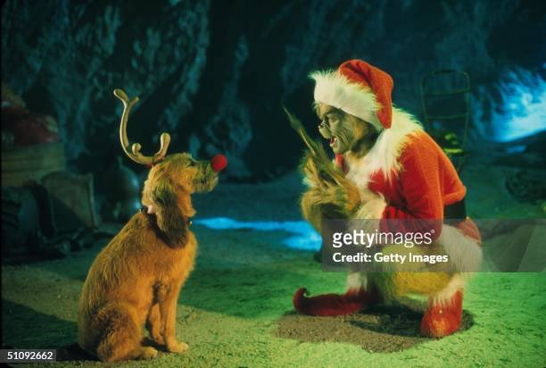 The Grinch, Played By Jim Carrey, Conspires With His Dog Max To Deprive The Who's Of Their Favorite Holiday In The Live-Action Adaptation Of The...