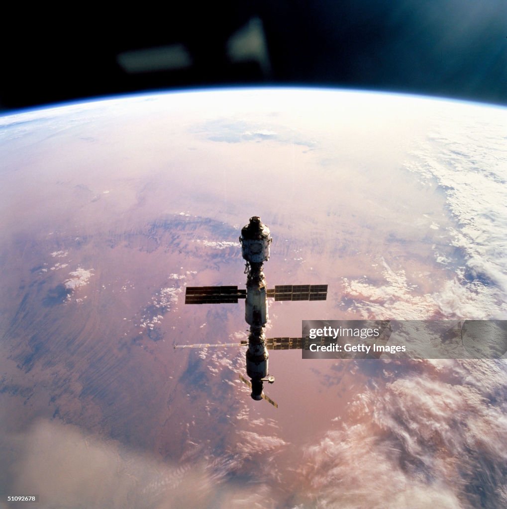 Silhouetted Over Earth The International Space Station (Iss Is Seen In A Configuration