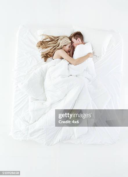 above view of couple sleeping on bed - bed on white stock pictures, royalty-free photos & images