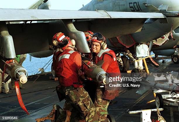 Air Force Personnel Move Ordnance Into Place October 7, 2001 While On Board The USS Enterprise. Aircraft Are Readied For Strike Missions Against Al...