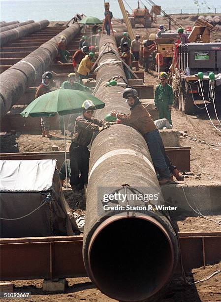 Workers Prepare Sections Of Pipe That Will Transport Oil Brought From Azerbaijans Caspian Sea, To A Holding Facility Off The Coast Of The Georgian...