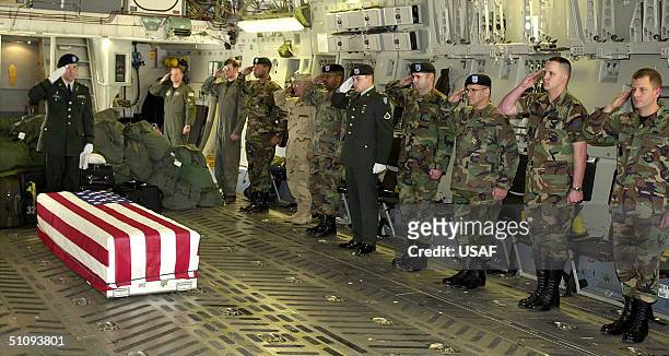 Military Personnel Pay Their Respects To Chief Petty Officer Matthew J. Bourgeois Of Tallahasse, Fl As His Remains Arrive March 29, 2002 Aboard A...