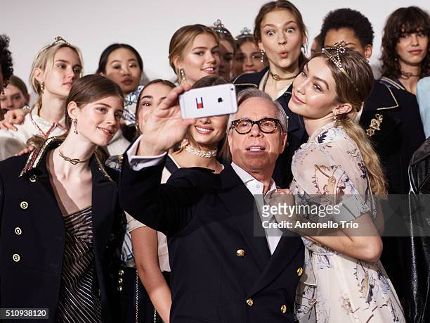 The designer Tommy Hilfiger poses with models backstage at the Tommy Hilfiger Women's Fall 2016 show during New York Fashion Week: The Shows at Park...