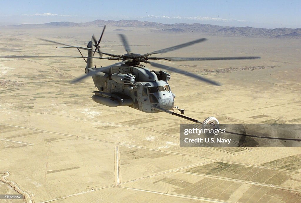 Marine Ch 53E Super Stallion Is Refueled In The Air By A Kc 130 Hercules Before Making
