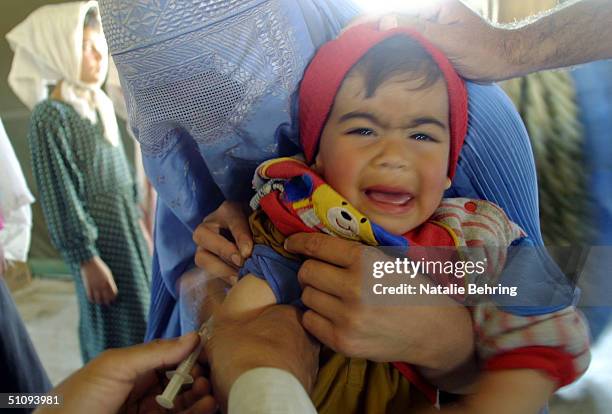 An Afghan Refugee Child Receives A Measles Innoculation At A Processing And Distribution Center After Returning From Pakistan May 2, 2002 In Puli...