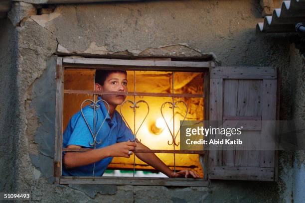 Palestinian Boy Looks From A Window Of His House During Clashes Between Israeli Troops And Palestinians May 29, 2002 In The Rafah Refugee Camp, Near...