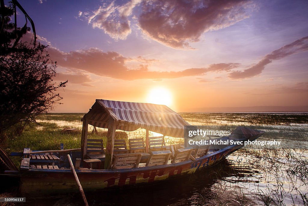 Wooden boat during sunset on the lake