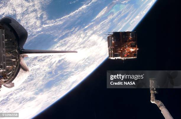 Backdropped Against The Blackness Of Space And Earth's Horizon, Spartan 201-05 Leaves The Cargo Bay Of The Space Shuttle Discovery. The Satellite...