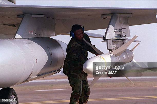 Weapons Technician Anthony Toliver, Secures A Agm-88 High-Speed Anti-Radiation Missile , At The End Of Of The Runway After The F-16Cj Aircraft Return...