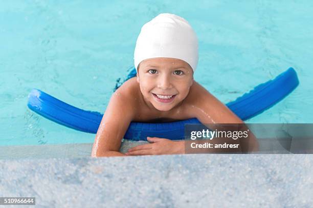 boy in the pool learning how to swim - hydrotherapy stock pictures, royalty-free photos & images