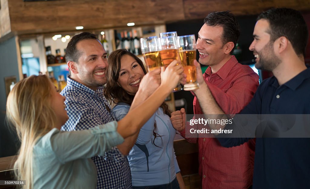 Group of friends having drinks at the bar